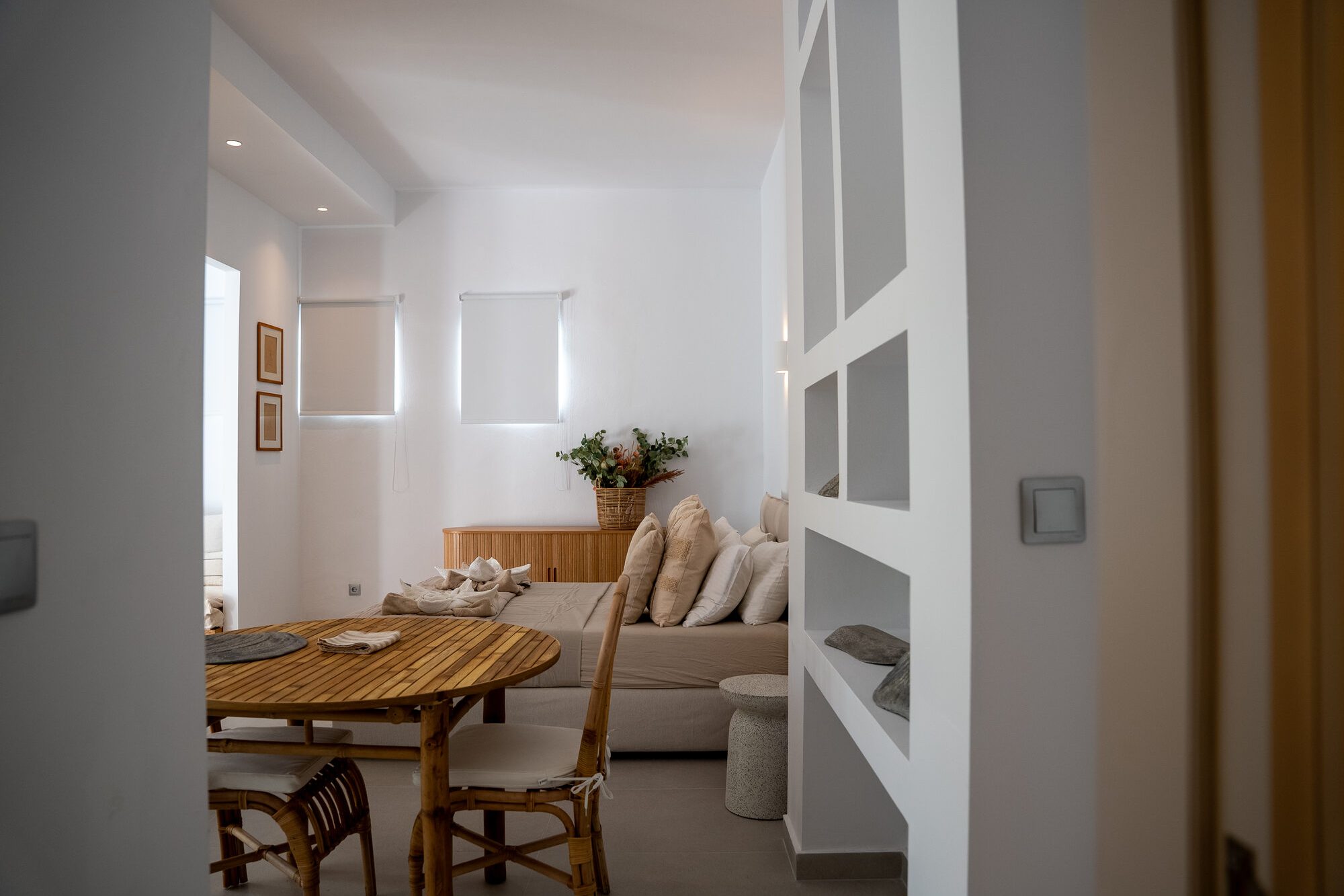 Bright open-plan living and dining area of the Rodos City suite at golden hour